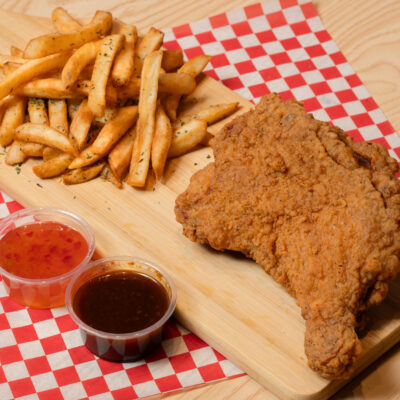 fried chicken leg with fries on a table