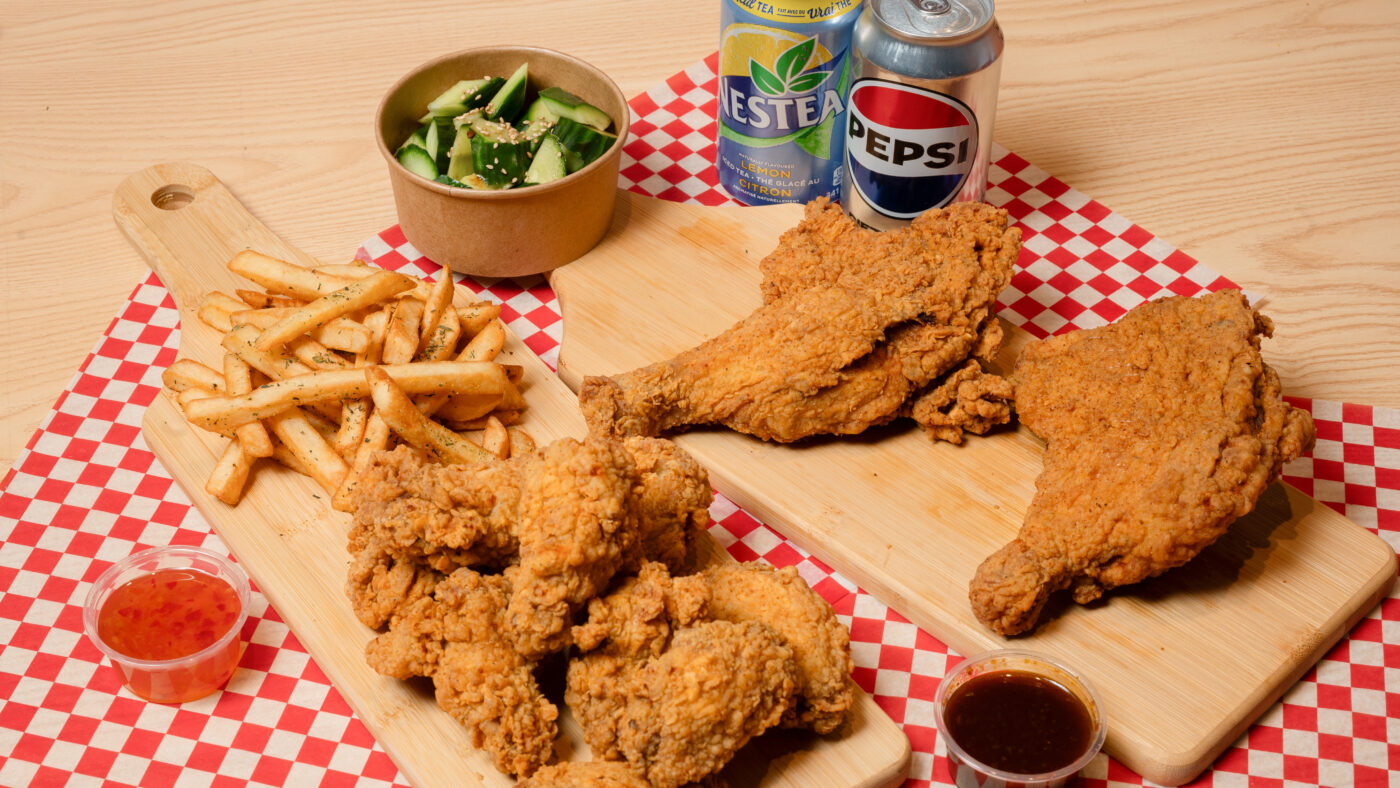 plates of fried chicken, sides, and drinks